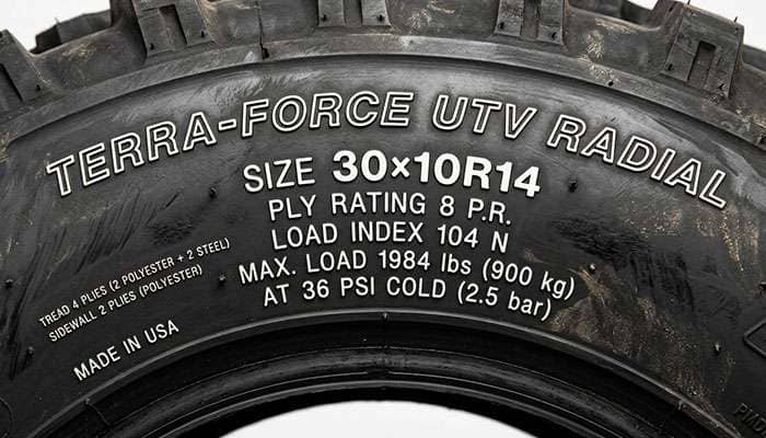 Close-up of a UTV tire sidewall showing ply rating and load markings