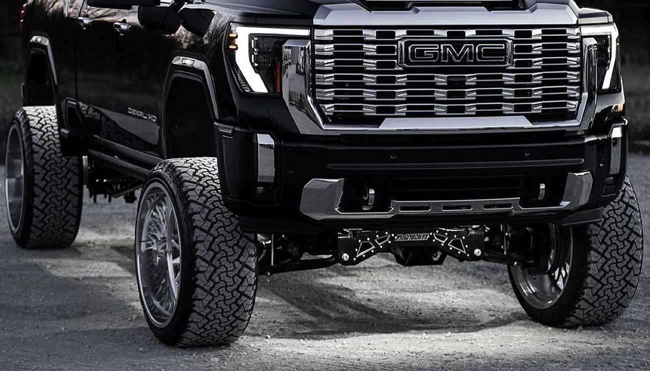 Close-up of a rugged off-road tire on a black vehicle