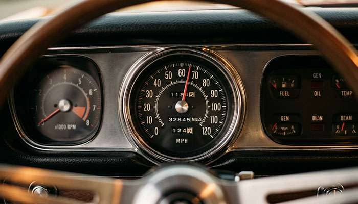 Close-up of a classic 1960s automobile speedometer showing the 120 MPH maximum scale typical of American muscle cars and full-size sedans of the era