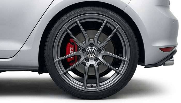 Close-up of a silver Volkswagen Golf rear wheel with multi-spoke Curva Concepts rim and low-profile tire fitment
