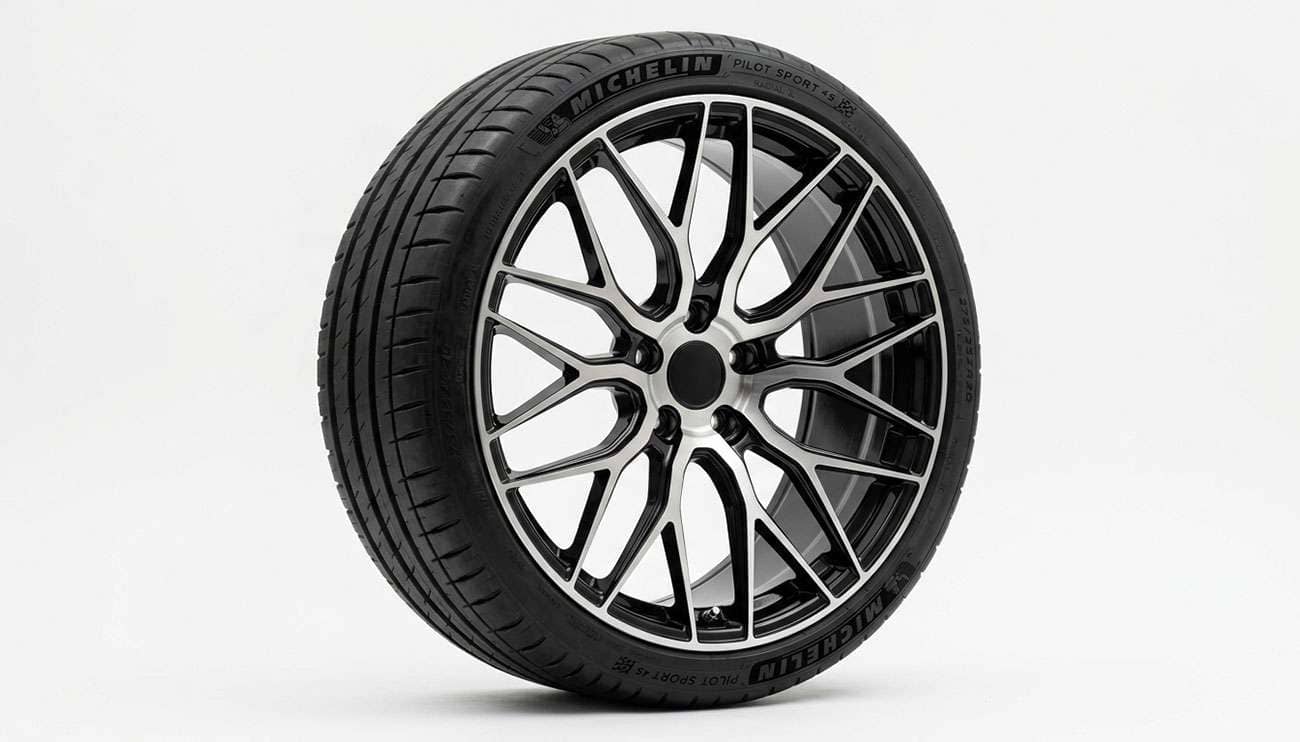 Twenty inch by eight and a half inch alloy wheel photographed face-on with a low profile tire mounted, on a clean white seamless backdrop