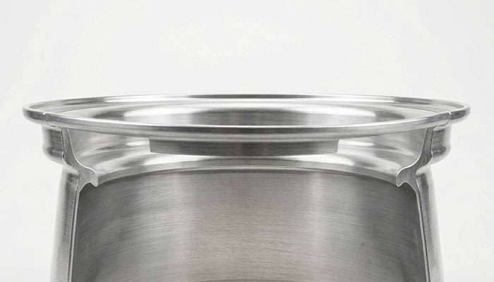 Close-up of the bead seat area of a bare wheel rim on a clean white studio backdrop