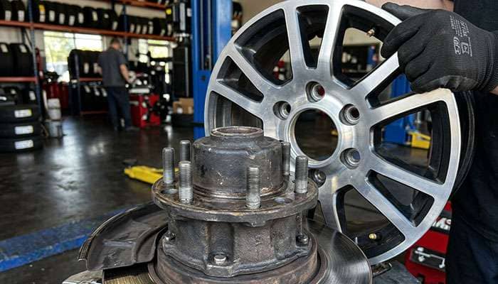 Close-up of a truck wheel center bore held against a larger wheel hub, showing the hub cannot pass through the bore