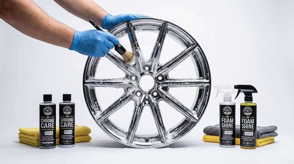 Person cleaning chrome wheel with brush using professional wheel cleaning products and microfiber towels