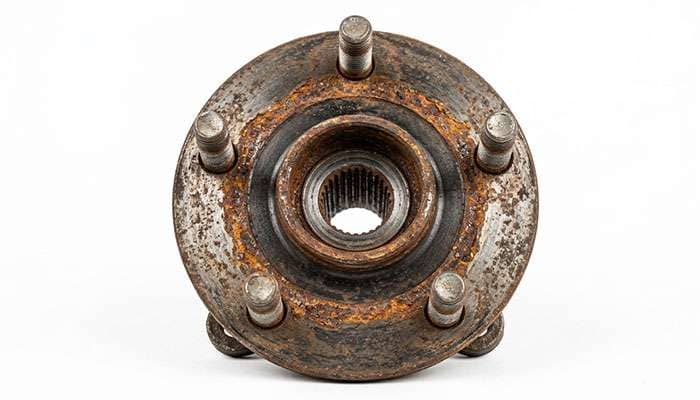 Close-up of wheel hub face showing rust corrosion ring around the center bore
