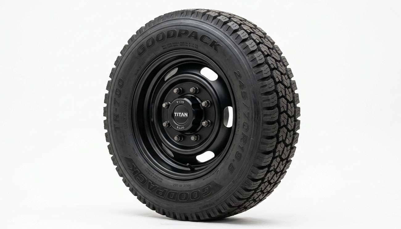 Heavy-duty truck wheel and tire rated for high load capacity on a clean white studio backdrop