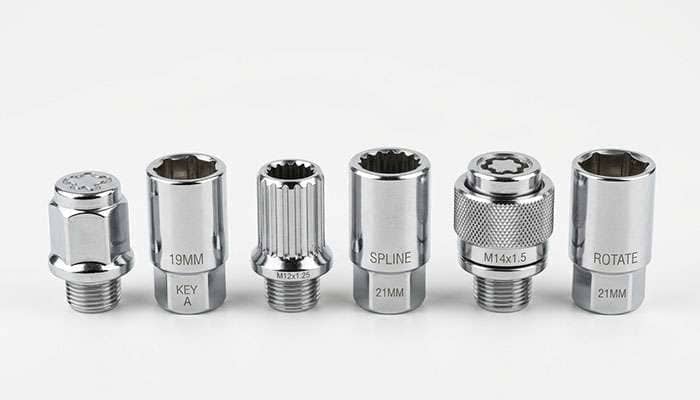 Three different types of wheel locks showing keyed spline and rotating collar designs side by side on a clean white surface