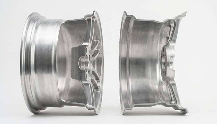 Two identically sized wheels shown side by side with different mounting pad positions
