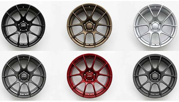 Array of powder coated wheels showing different finishes including gloss black matte bronze and satin silver