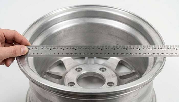 Rim width being measured across the inside bead seats of a wheel with a ruler