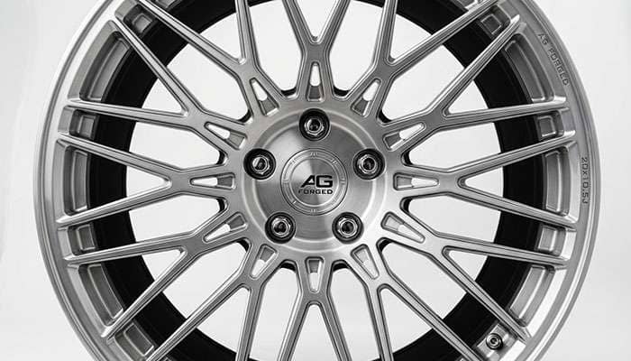 Close-up of custom wheel showing intricate split-spoke pattern with polished finish