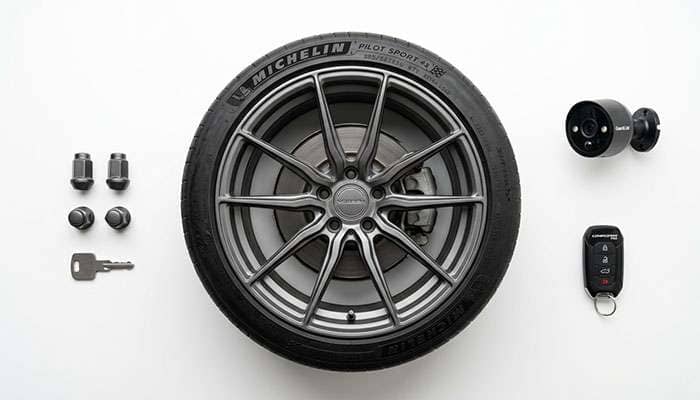 Custom wheel protected by multiple security measures including locking lugs and security camera on a clean white surface