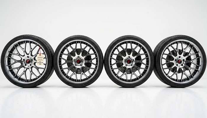 Expensive custom wheels on a truck parked in a dark area illustrating wheel theft risk factors on a clean neutral surface