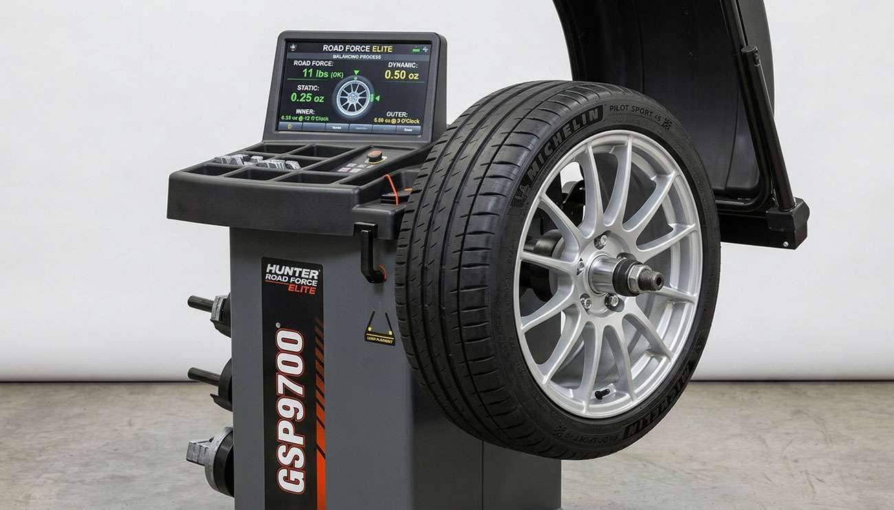 Mounted wheel and tire on a Hunter road force balancing machine showing readout display