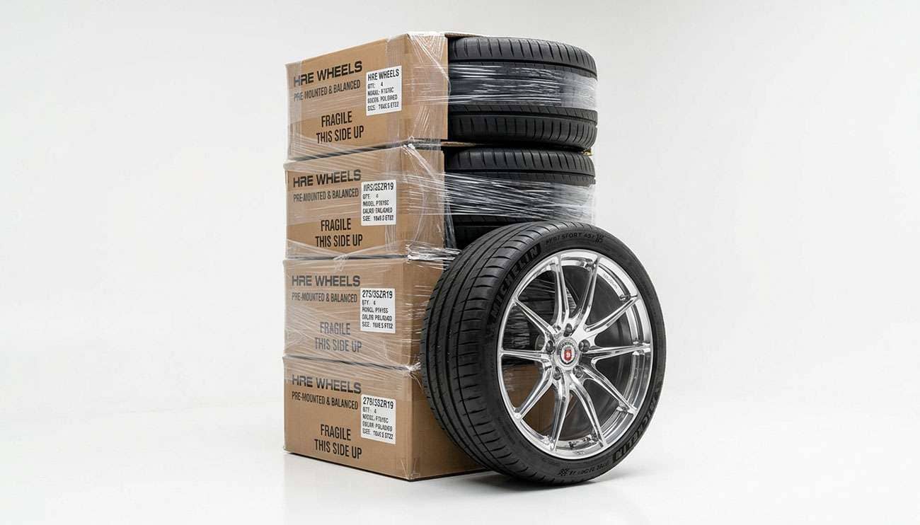 Wheel and tire package boxes being inspected on a shop floor before installation