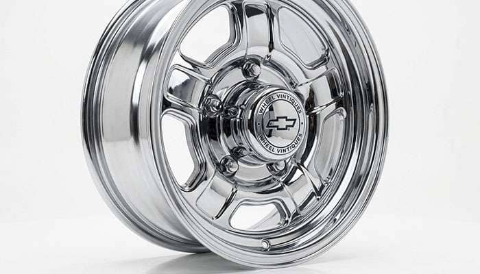 Close-up of a Wheel Vintiques triple-chrome finish with a factory-style center cap