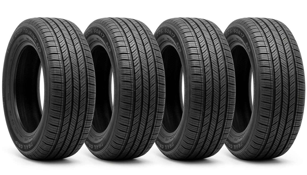 Four 225/60R17 all-season touring tires standing in a row on a clean white backdrop