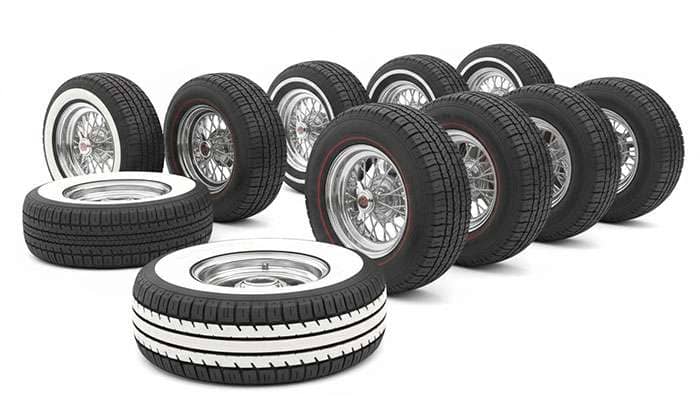 Classic car tires featuring wide whitewall and redline sidewall treatments from different automotive eras