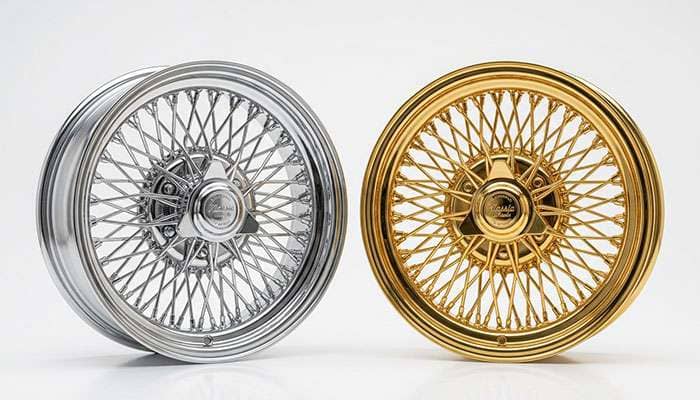 Chrome and gold-finish wire wheels shown side by side on a white studio backdrop
