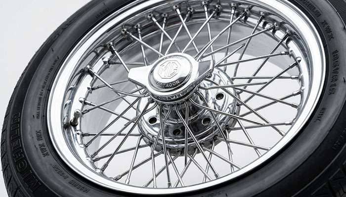 Close-up of criss-cross wire wheel spoke lacing between the rim and center hub