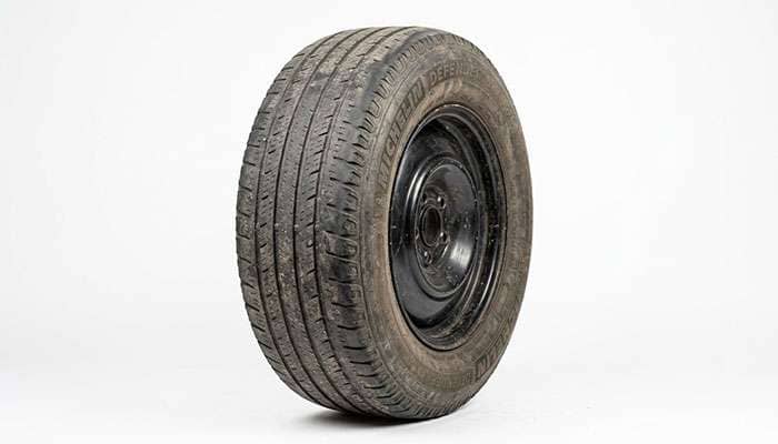 Worn tire with low tread depth, a common cause of squealing tires