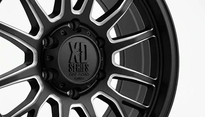 Close-up of an XD Series cast-aluminum wheel spoke and center cap detail on a clean white seamless backdrop