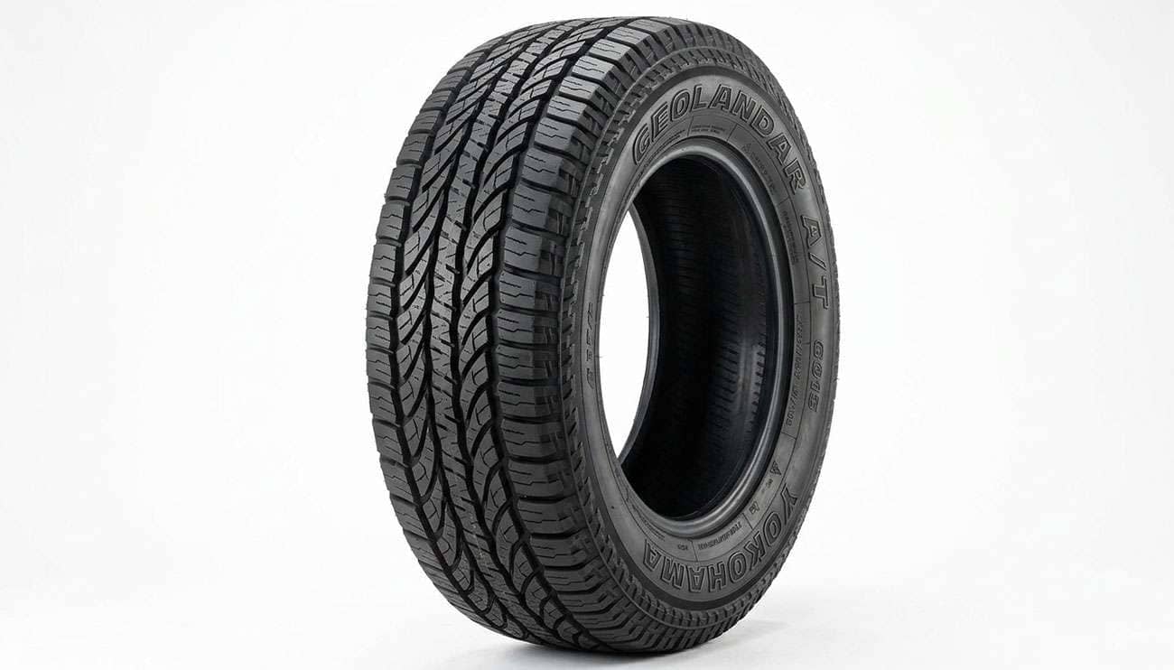 Yokohama Geolandar A/T G015 all-terrain tire with raised YOKOHAMA and GEOLANDAR lettering on the sidewall shown on a clean white seamless backdrop