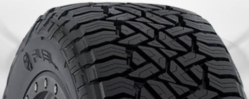 All-terrain tire showing aggressive chunky tread blocks designed for both on-road and off-road use