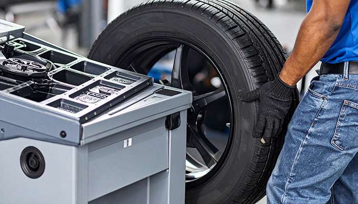 Technician balancing tires