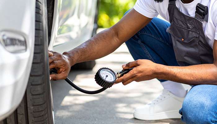 Technician checking Tire Pressure