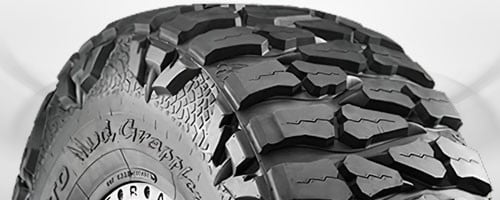 Mud-terrain tire featuring large aggressive lugs with wide spacing for extreme off-road conditions