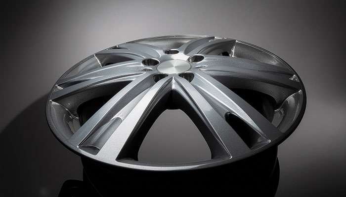 Close-up of an aluminum alloy wheel with machined spokes.