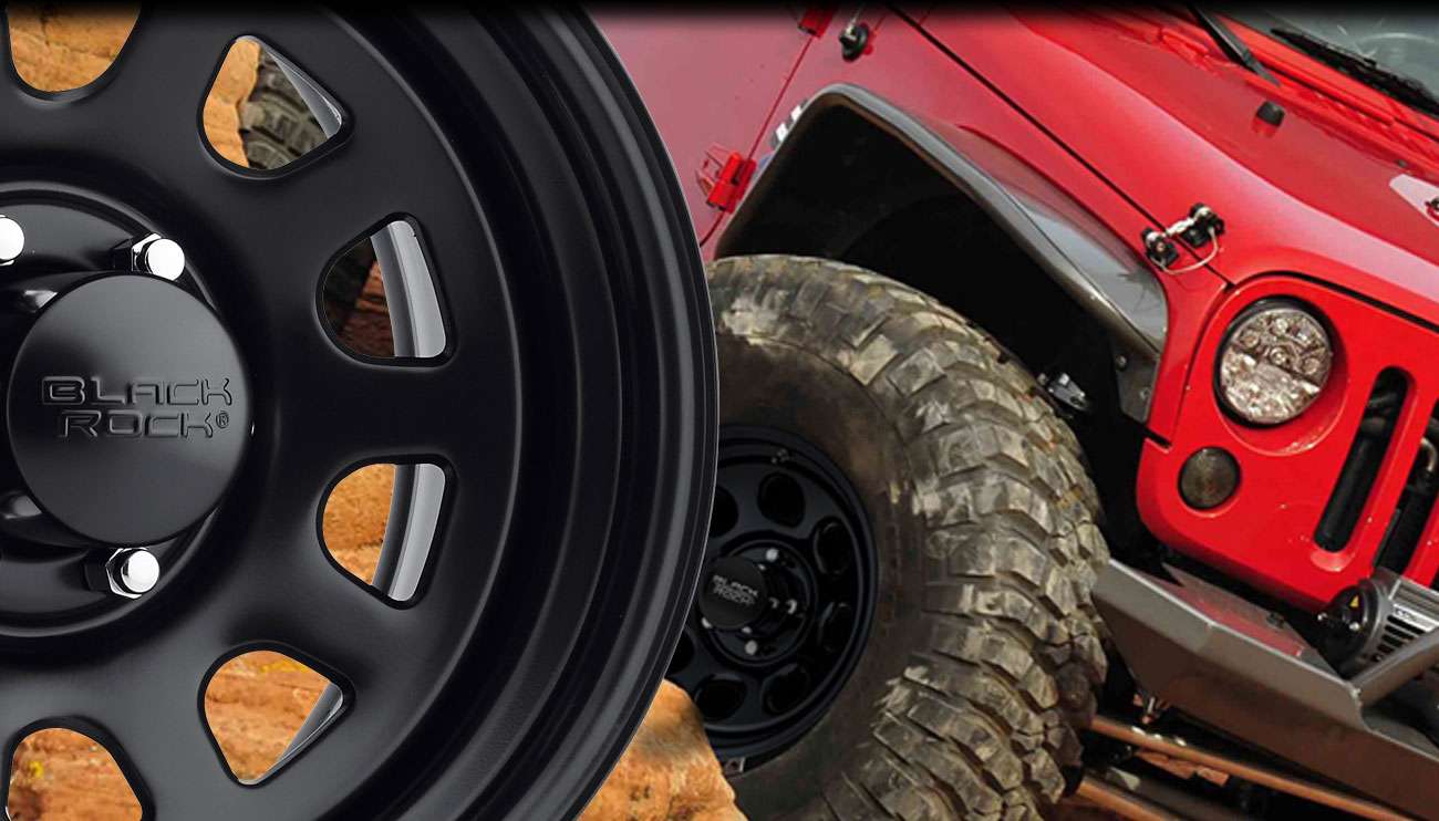 Close-up of a rugged Black Rock off-road wheel on a red vehicle