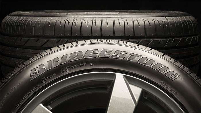 Close-up of a Bridgestone tire with visible tread pattern and brand name on the sidewall, 2025 review image