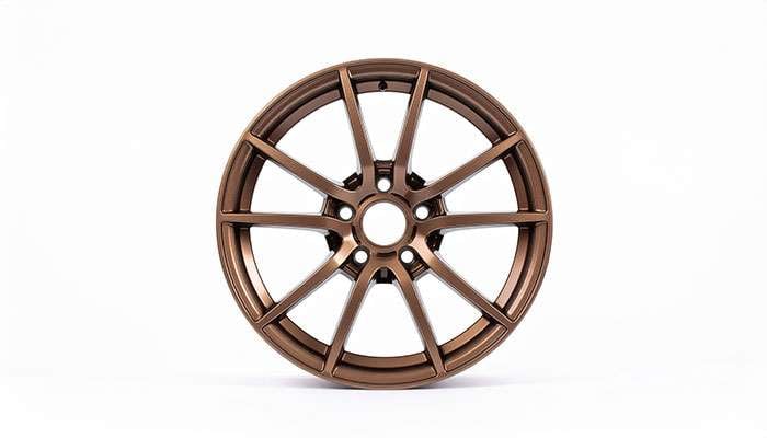 Close-up view of bronze wheel showing detailed spoke design and metallic finish highlighting quality craftsmanship