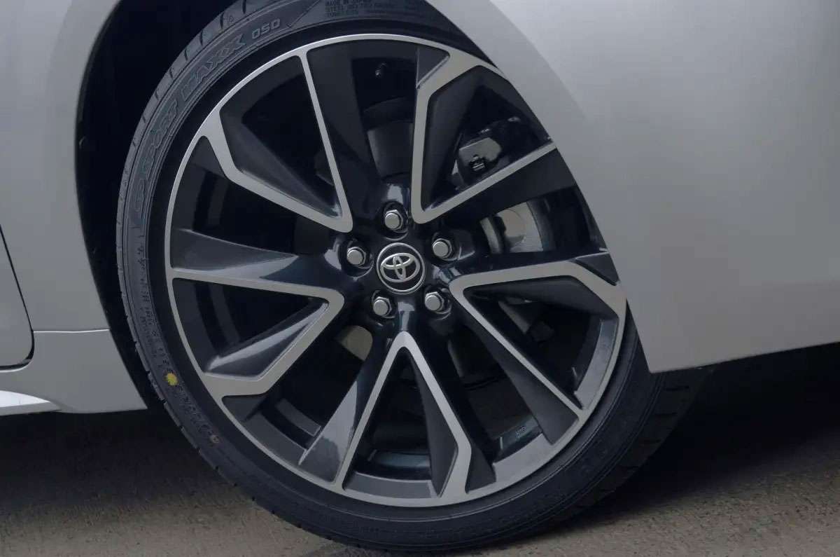 Close-up of a 2025 Toyota Corolla alloy wheel with a sleek black and silver multi-spoke design.