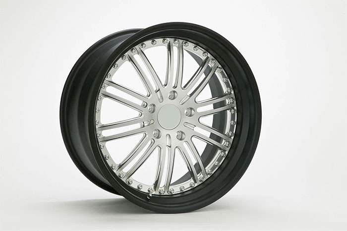Close-up of a sleek, multi-spoke chrome car wheel rim with black outer edge on a white background