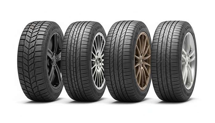 Four different car tires with distinct tread patterns and alloy rims displayed side by side