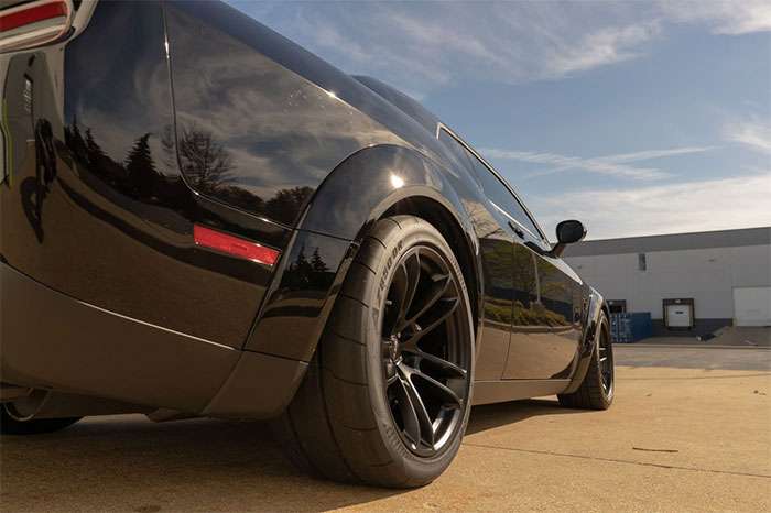 Close-up of drag radial tire showing minimal tread pattern and soft compound construction