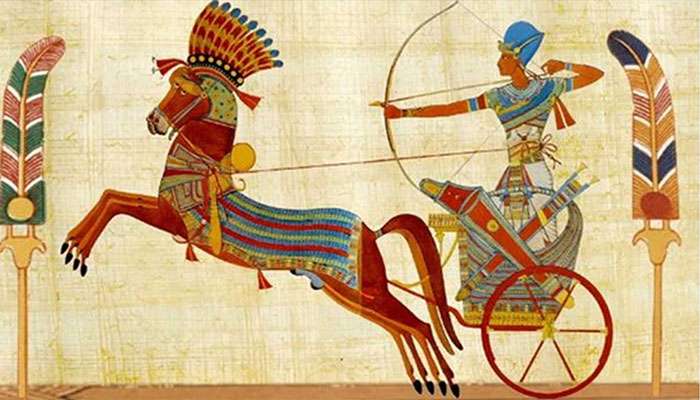 Ancient Egyptian warrior in a chariot drawn by a decorated horse, aiming a bow and arrow in a historic scene.