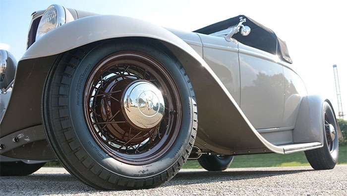 Firestone Deluxe Champion bias-ply classic tire—pie-crust sidewall on period wheel