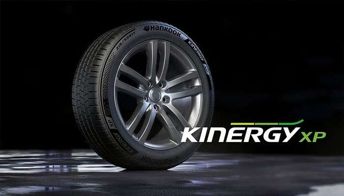 Hankook Kinergy XP all-season tire with alloy wheel displayed on a dark background with logo text beside it