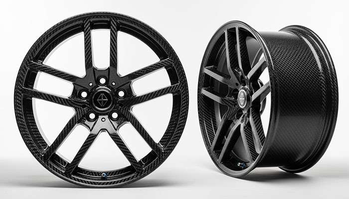 Ultra-premium carbon fiber wheels displaying exotic materials and multi-piece construction