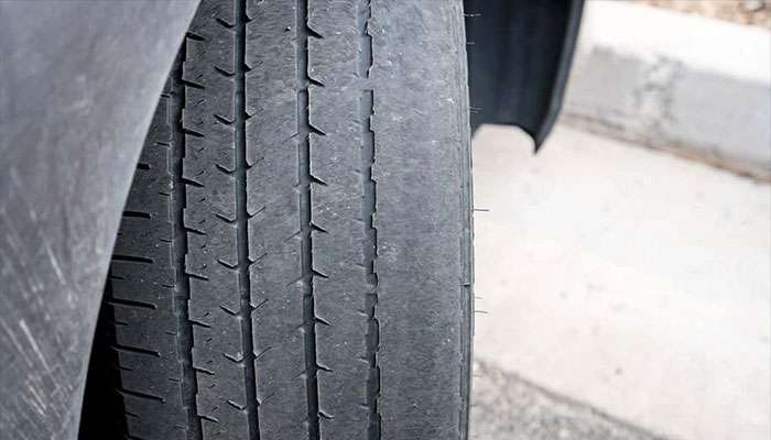 Uneven tire wear pattern caused by improper wheel alignment.