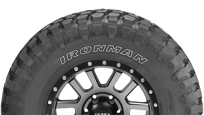 Ironman off-road tire with aggressive tread pattern mounted on black alloy wheel