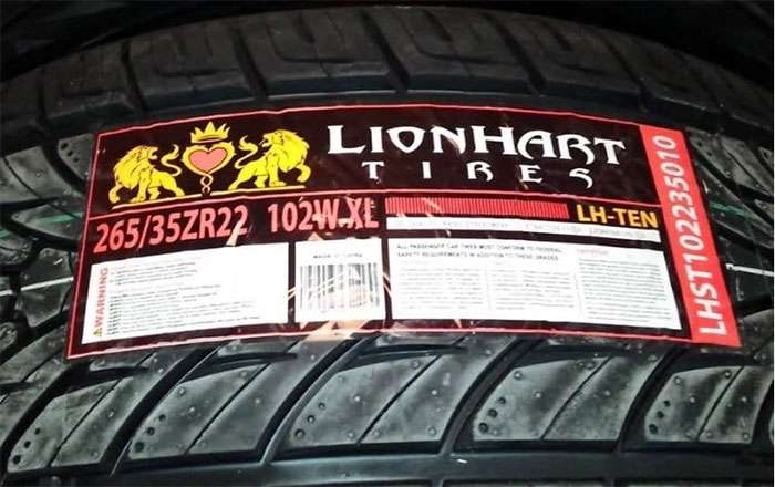 Close-up of a Lionhart Tires label showing tire size 265/35ZR22 and model LH-TEN on a black tire tread