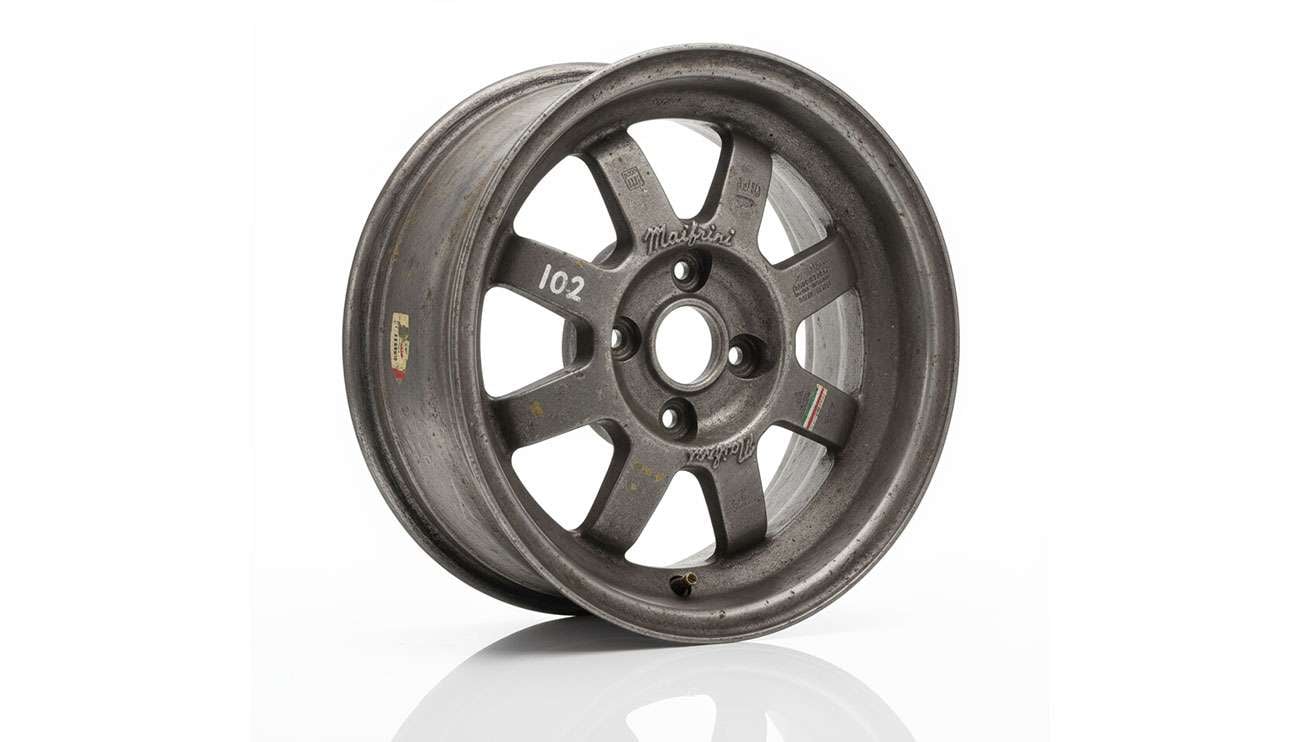 Close-up of vintage Maifrini Mille Miglia magnesium alloy wheel showing wear and racing heritage markings
