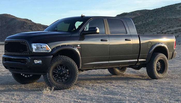 Black off-road pickup truck with Mayhem 8107 Cogent gloss black wheels featuring milled spokes in desert setting