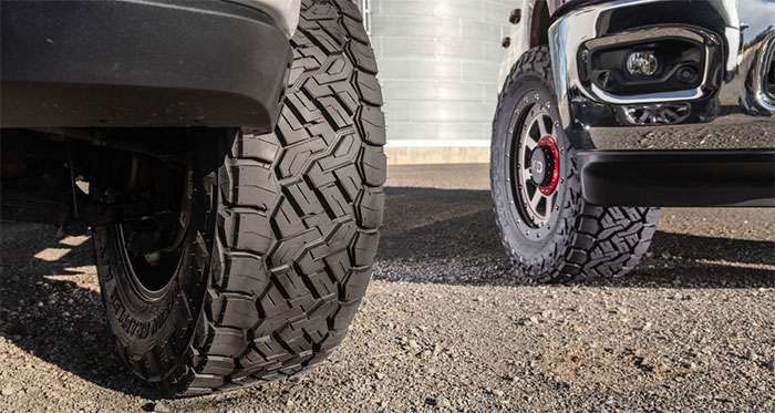 Nitto Recon Grappler A/T tire with aggressive tread on rocky off-road surface.
