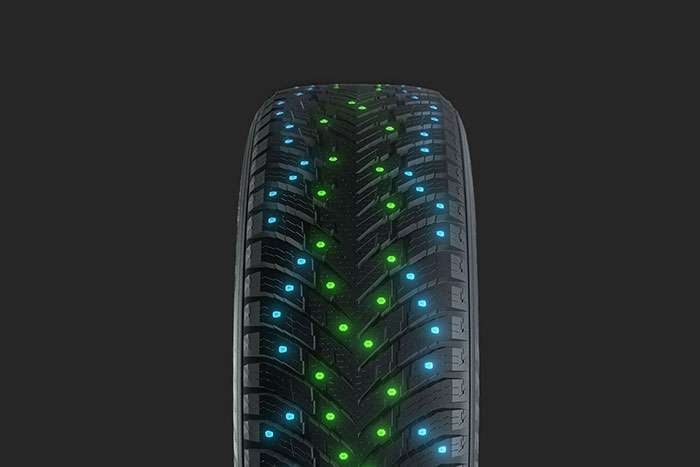 Nokian Tires Hakkapeliitta 10 SUV studded tire with a molecular structure illustration highlighting advanced safety features